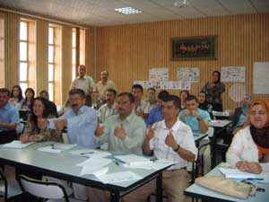 Deaf teachers demonstrating sign language and hearing teachers practising it