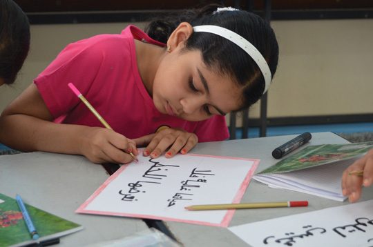 Grade 4 student writing a slogan about protecting the environment