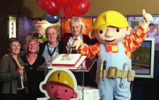 Susie Miles from EENET and the founders of Inclusive Technology celebrate 10 years. (Children’s TV character, Bob the Builder, is cutting the birthday cake!)