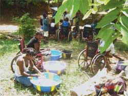 Children help each other with washing clothes