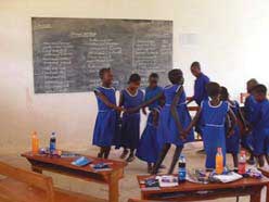 Children help each other with washing clothes