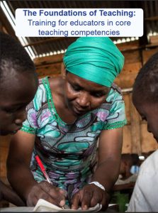 Toolkit cover page. Photo shows female teaher learning over desk writing, with child either side of her