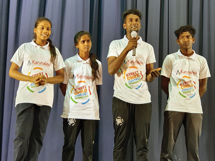 Players speaking to secondary school students about participating in the Street Child Cricket World Cup