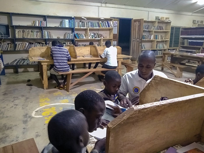 Parents and children in a library in Ghana